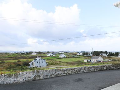 A rural landscape with scattered houses and green fields at Ard an Phiobaire An Luinnigh near Derrybeg County Donegal