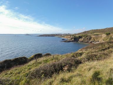 A coastal landscape with grassy cliffs overlooking the sea at Kernyk in Perranuthnoe