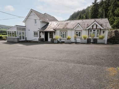 A house with windows and planters at Pengwern in Llanrwst