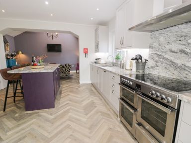 A kitchen with an island and appliances at Pengwern in Llanrwst