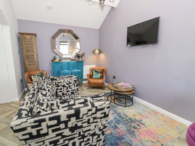 A living room with a coffee table and sofa at Pengwern in Llanrwst