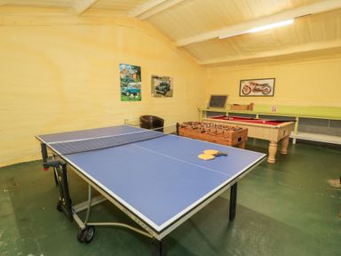 A games room with a table tennis table and other games at Pengwern in Llanrwst