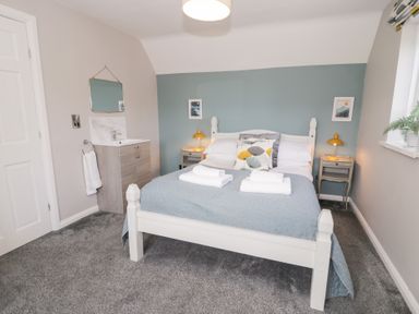 A bedroom with a bed and side tables at Pengwern in Llanrwst