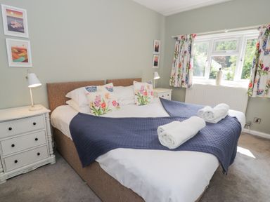 A bedroom with a bed and bedside table at Pengwern in Llanrwst
