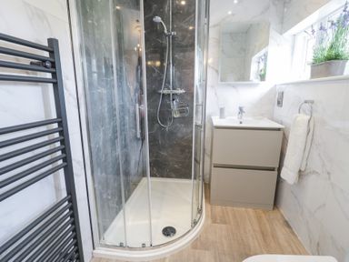 A bathroom with a shower and vanity unit at Pengwern in Llanrwst