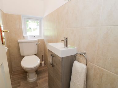 A bathroom with a toilet and sink at Pengwern in Llanrwst