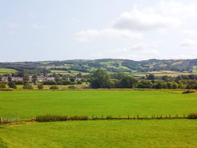 A view of green fields and hills at Pengwern in Llanrwst