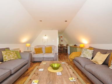 A living room with sofas cushions wooden coffee table and lamps at 59 Valley Lodge Callington near Gunnislake