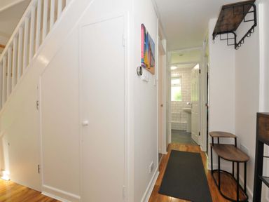 A hallway with a staircase storage area and doors leading to other rooms at 59 Valley Lodge Callington near Gunnislake