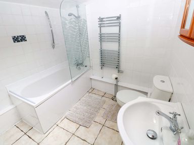 A bathroom with a bathtub, shower, toilet, and sink at The Nook Star near Cenarth