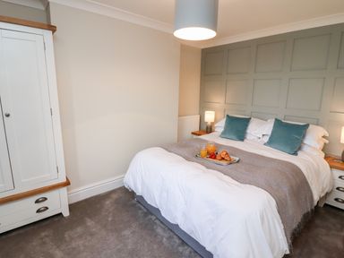 A bedroom with a double bed and two bedside tables with lamps at Mariners Watch in Whitby