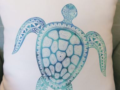 A cushion with a blue and white turtle design at Atlantis in St Ives