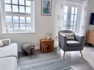 A living room with a sofa and an armchair at Harbour View in Porthmadog