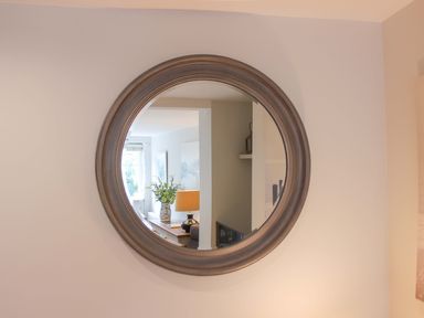 A mirror reflecting a living room at Simples in Dartmouth