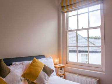 A bedroom with a bed and window at Simples in Dartmouth