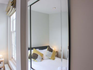 A bedroom with a bed and pillows at Simples in Dartmouth