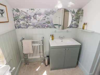 A bathroom with a mirror and sink at Heath Cottage Stratford-Upon-Avon
