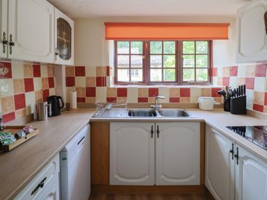 A kitchen with cabinets and a sink at The Old Bakery in South Perrott near Mosterton