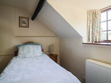 A bedroom with a single bed and a window at The Old Bakery South Perrott near Mosterton
