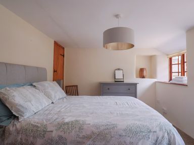 A bedroom with a bed and a drawer unit at Jasmine Cottage South Perrott near Mosterton