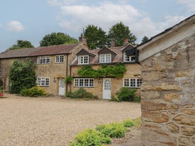 A house with windows and a door at Jasmine Cottage in South Perrott near Mosterton