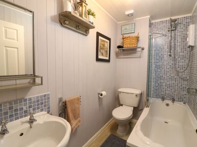 A bathroom with a sink mirror toilet bathtub and a shower at Harbour Reach Brewers Quay Harbour