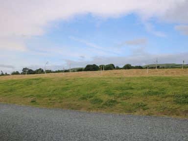 A gravel path next to a grassy field with small trees and hills in the background at Kerry Hill The Sheepfold in Llanyre near Llandrindod Wells