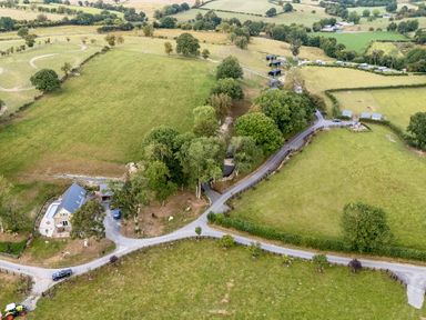An aerial view of a house with fields and trees at The Fox Den Nantmel near Rhayader