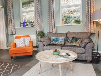 A living room with a sofa and armchair at Ferndale in Lynton