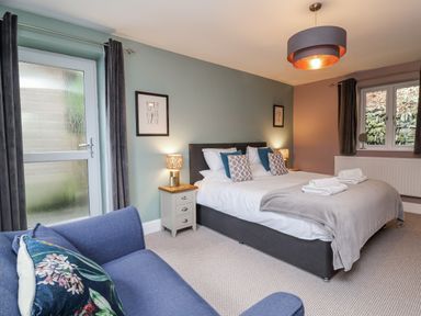 A bedroom with a bed and sofa at Ferndale in Lynton