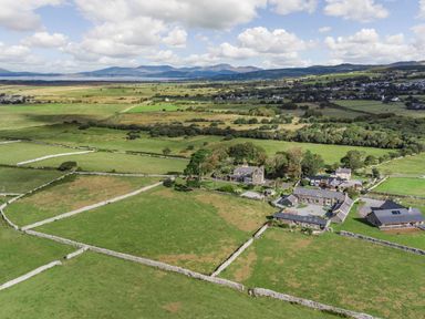 A rural area with fields divided by stone walls and houses at Bennar Fawr in Dyffryn Ardudwy