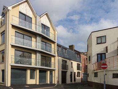 A street view with modern and traditional buildings and a no entry sign at Harbourside Haven Apartment 2 in Weymouth