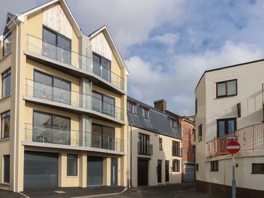 A street view with modern and older residential buildings and a no entry sign at Harbourside Haven Penthouse 2 Weymouth