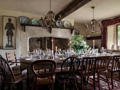 A dining room with a table set for dinner at Reybridge House in Lacock