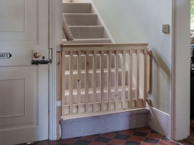 A staircase with a wooden gate and a door at Reybridge House in Lacock