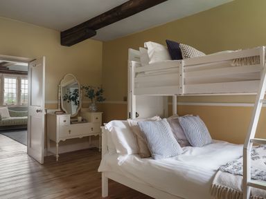 A bedroom with a bunk bed and a single bed at Reybridge House in Lacock