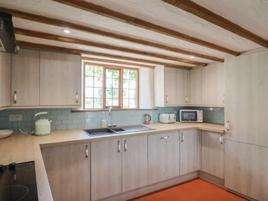 A kitchen with cabinets, a sink, and a microwave at Garden View in Wellington