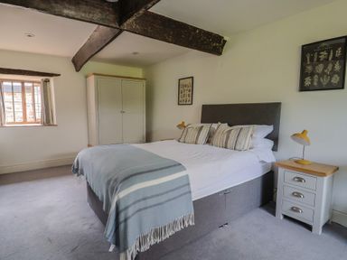 A bedroom with a bed and wardrobe at Garden View in Wellington