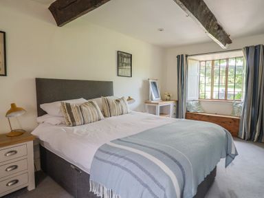 A bedroom with a bed and a window at Garden View in Wellington