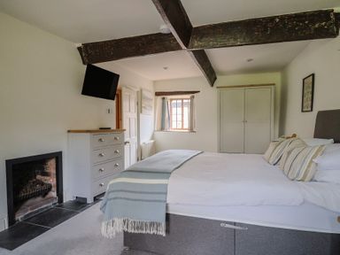 A bedroom with a bed and fireplace at Garden View in Wellington