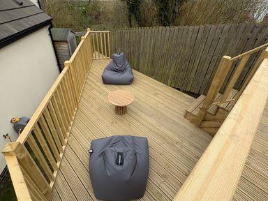 An outdoor space with bean bags and a table at Summer Rose in Craster