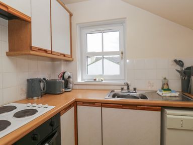 A kitchen with a sink and stove at Walkers Retreat in Keswick
