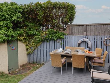 An outdoor dining area with a table and chairs at Over Esk in Whitby