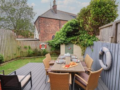 A garden with a table and chairs at Over Esk in Whitby