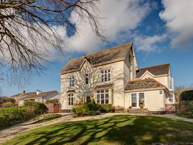 A detached house with multiple windows and a small garden at Victoria Lodge in Kingsbridge
