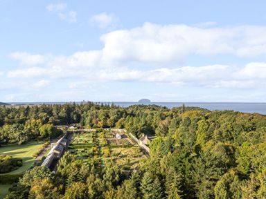 A large estate with gardens surrounded by trees near a body of water at Ardlochan Lodge - Culzean Castle in Maybole