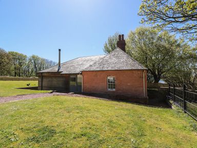 A house with a chimney in an outdoor area at Ardlochan Lodge - Culzean Castle in Maybole