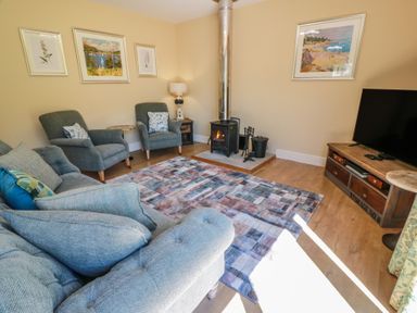 A living room with a sofa and armchairs at Ardlochan Lodge - Culzean Castle Maybole
