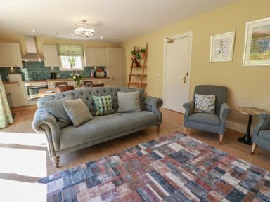 A living room with a sofa and armchairs at Ardlochan Lodge - Culzean Castle in Maybole
