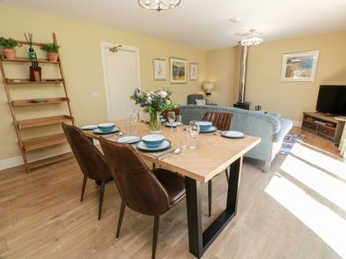 A dining room with a table and chairs at Ardlochan Lodge - Culzean Castle, Maybole